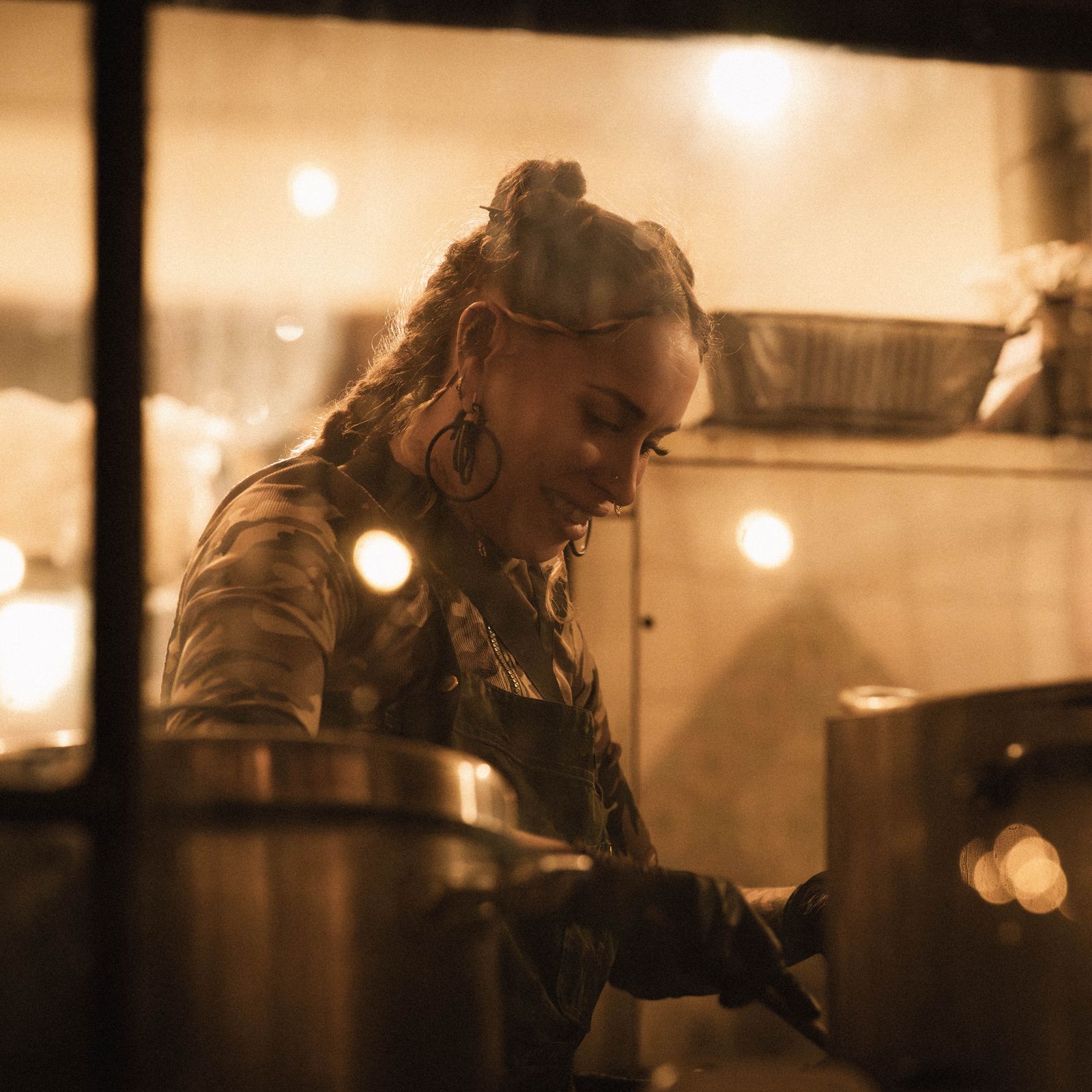 Chef Elena Rivas cooking on the line at Sol y Sabor